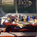 On the covered rear deck of the ship is an inviting table where you can enjoy your meals.