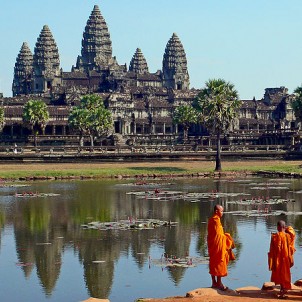 Buddhist Monks in front of the Angkor Wat in Cambodia. Photo via Wikimedia Commons:sam graza
