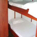 The two cabins below deck have two beds arranged one above the other.