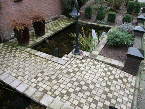 Front entrance to townhouse with small fish pond