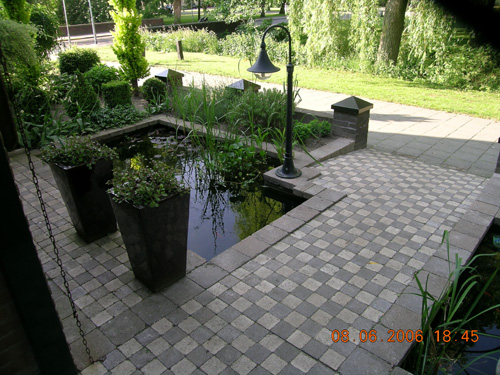 Front entrance to townhouse with small fish pond